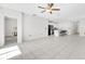 Bright, open floor plan showcasing a tile floor and connecting the living room to the modern kitchen at 797 Olive Conch St, Ruskin, FL 33570
