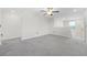 Spacious open loft area with carpet, ceiling fan, and a bright window overlooking neighborhood at 797 Olive Conch St, Ruskin, FL 33570