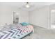Bright main bedroom boasting neutral carpet, a ceiling fan, and a doorway leading to the ensuite bathroom at 797 Olive Conch St, Ruskin, FL 33570