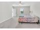 Spacious main bedroom featuring neutral carpet, a ceiling fan, and natural light from the window at 797 Olive Conch St, Ruskin, FL 33570
