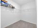 Bright walk-in closet featuring carpeted floor, white walls, and wire shelving for optimal storage at 797 Olive Conch St, Ruskin, FL 33570