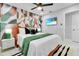 Stylized bedroom featuring a bold accent wall, a flat-screen TV, and modern furniture at 8010 W Hiawatha St, Tampa, FL 33615