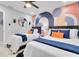 Stylish bedroom featuring matching twin beds, a modern accent wall, and decor at 8010 W Hiawatha St, Tampa, FL 33615