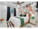 Bright bedroom with a modern accent wall, ceiling fan, and plush bedding at 8010 W Hiawatha St, Tampa, FL 33615