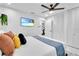 Bright bedroom with a flat-screen TV, a closet, and trendy decorations at 8010 W Hiawatha St, Tampa, FL 33615
