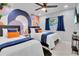 Stylish bedroom featuring matching twin beds, a modern accent wall, and decor at 8010 W Hiawatha St, Tampa, FL 33615