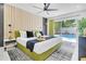 Inviting bedroom with a plush bed, modern decor, and a view of the sparkling pool at 8010 W Hiawatha St, Tampa, FL 33615