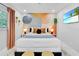 Cozy bedroom with an artistic accent wall, modern lighting, and stylish decor at 8010 W Hiawatha St, Tampa, FL 33615