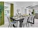 Elegant dining room with a dark wood table set for a meal and lots of natural light at 8010 W Hiawatha St, Tampa, FL 33615