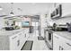 Modern kitchen with an open floor plan, sleek countertops and marble floors, and stainless appliances at 8010 W Hiawatha St, Tampa, FL 33615