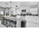 Bright kitchen featuring a large marble island with seating and stainless-steel appliances at 8010 W Hiawatha St, Tampa, FL 33615