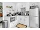 Well-equipped kitchen with white cabinets, modern appliances, and stylish black and white backsplash at 8010 W Hiawatha St, Tampa, FL 33615
