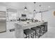Modern kitchen features sleek countertops, stainless steel appliances, and an island with bar seating at 8010 W Hiawatha St, Tampa, FL 33615