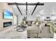 Bright living room with vaulted ceilings, exposed beams, stylish decor, and an electric fireplace at 8010 W Hiawatha St, Tampa, FL 33615