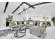 Spacious living room with vaulted ceilings, beam accents, modern lighting and an open floorplan at 8010 W Hiawatha St, Tampa, FL 33615