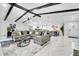 Expansive living room with open floorplan, vaulted ceilings, and stylish decor, open to dining and kitchen at 8010 W Hiawatha St, Tampa, FL 33615