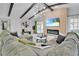 Beautiful living room features vaulted ceilings with exposed beams, stylish decor, and fireplace at 8010 W Hiawatha St, Tampa, FL 33615