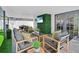Relaxing covered patio showcasing comfortable lounge seating, an outdoor television, and modern decor at 8010 W Hiawatha St, Tampa, FL 33615