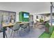 Charming covered patio with dining, lounge seating, and outdoor television perfect for relaxing and entertaining at 8010 W Hiawatha St, Tampa, FL 33615
