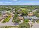 Aerial view of the house in a treed neighborhood on a sunny day at 8405 Woodbridge Blvd, Tampa, FL 33615