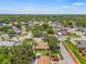 This aerial showcases a charming single-Gathering home on a tree-lined street in a desirable neighborhood at 8405 Woodbridge Blvd, Tampa, FL 33615