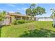 Backyard with lush green lawn and privacy fence at 8405 Woodbridge Blvd, Tampa, FL 33615