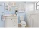 Bright bathroom featuring a white vanity, toilet, and walk-in tub at 8405 Woodbridge Blvd, Tampa, FL 33615