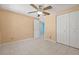 Bedroom with neutral walls, tile flooring, a closet, and ceiling fan at 8405 Woodbridge Blvd, Tampa, FL 33615