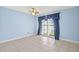 Blue bedroom featuring a window with blue curtains and tile flooring at 8405 Woodbridge Blvd, Tampa, FL 33615
