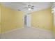 Bedroom featuring tile floors, ceiling fan, and an ensuite bathroom at 8405 Woodbridge Blvd, Tampa, FL 33615