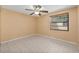 Bedroom with neutral walls, tile flooring, and a window with blinds at 8405 Woodbridge Blvd, Tampa, FL 33615