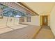Spacious covered patio with a stained wood deck, ideal for outdoor living and entertaining at 8405 Woodbridge Blvd, Tampa, FL 33615