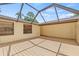 Spacious covered patio with wood deck and windows, creating a relaxing outdoor space at 8405 Woodbridge Blvd, Tampa, FL 33615