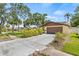A charming home featuring a two-car garage and lush landscaping for added curb appeal at 8405 Woodbridge Blvd, Tampa, FL 33615