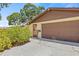 Close up of garage door with landscaping at 8405 Woodbridge Blvd, Tampa, FL 33615