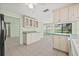 Bright eat-in kitchen with tile flooring and an open view to the living area at 8405 Woodbridge Blvd, Tampa, FL 33615