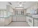 Well-lit kitchen with white appliances, tile flooring, and ample cabinet space at 8405 Woodbridge Blvd, Tampa, FL 33615