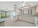 Bright kitchen with white cabinetry, tile flooring, and breakfast bar at 8405 Woodbridge Blvd, Tampa, FL 33615