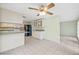 Open kitchen with white cabinets, a black refrigerator, and breakfast bar at 8405 Woodbridge Blvd, Tampa, FL 33615