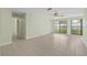 Bright living room with tile flooring, ceiling fan, and large windows at 8405 Woodbridge Blvd, Tampa, FL 33615
