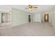 Open-concept living room with tile floors, ceiling fan, and view of the entry at 8405 Woodbridge Blvd, Tampa, FL 33615