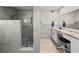 Modern bathroom showcasing a walk-in shower, gray tile and sleek vanity with ample counter space at 8718 Tahiti Ln, Tampa, FL 33615