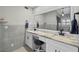 Bright bathroom features a double vanity, gray tile backsplash, and stylish fixtures at 8718 Tahiti Ln, Tampa, FL 33615