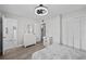 Bright bedroom with wood floors, dresser, and a view to the bathroom at 8718 Tahiti Ln, Tampa, FL 33615