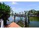 Private dock with a boat lift, blending convenience with the tranquility of waterfront living at 8718 Tahiti Ln, Tampa, FL 33615