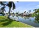 Scenic canal view with a lush lawn leading to boat docks under a clear sky at 8718 Tahiti Ln, Tampa, FL 33615