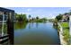 Wide canal view surrounded by tropical foliage, showcasing the essence of waterfront paradise at 8718 Tahiti Ln, Tampa, FL 33615