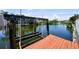 Waterfront property featuring a private boat lift offering direct access to the serene waterway at 8718 Tahiti Ln, Tampa, FL 33615