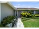 Inviting entryway with a landscaped walkway leading to the front door, surrounded by lush greenery at 8718 Tahiti Ln, Tampa, FL 33615