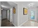 Bright hallway featuring tile flooring, decorative lighting, and easy access to rooms at 8718 Tahiti Ln, Tampa, FL 33615